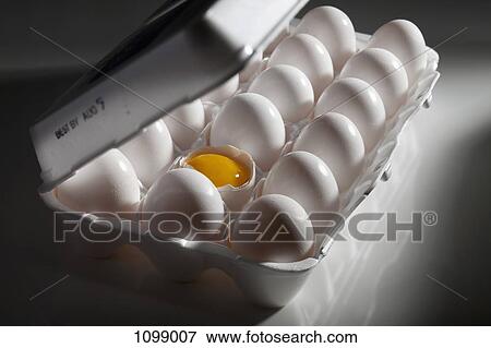 A broken egg and its yolk amongst eggs in a carton View Large Photo Image Stock Photo - A broken egg and its yolk amongst eggs in a carton. Fotosearch