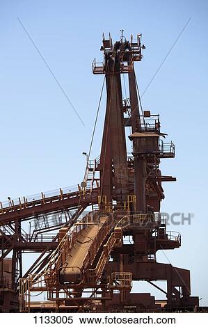 A bucket wheel reclaimer in an iron ore mine View Large Photo Image Stock Photography - A bucket wheel reclaimer in an iron ore mine. Fotosearch