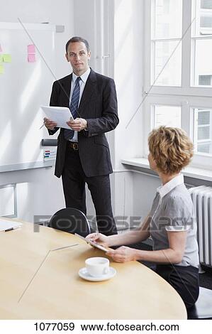 A businessman leading a meeting View Large Photo Image Stock Photo - A businessman leading a meeting. Fotosearch