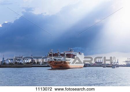 A cargo ship leaving the Hamburg harbor View Large Photo Image Stock Image - A cargo ship leaving the Hamburg harbor. Fotosearch