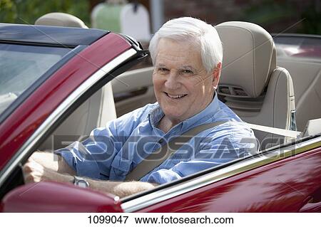 A cheerful senior man driving a convertible sports car View Large Photo Image Stock Photo - A cheerful senior man driving a convertible sports car. Fotosearch