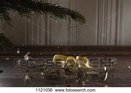 Stock Photograph - A Christmas bauble shattering. Fotosearch