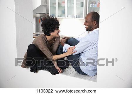 A couple sitting in an archway laughing View Large Photo Image Stock Image - A couple sitting in an archway laughing. Fotosearch