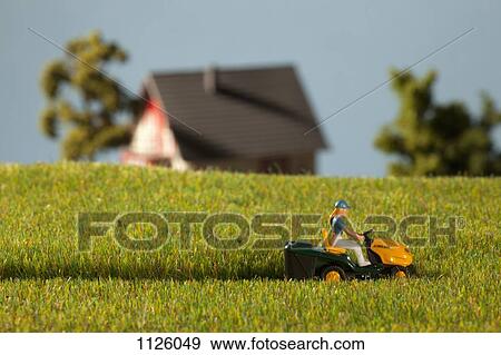 A diorama of a miniature figure using a riding lawnmower View Large Photo Image Stock Photo - A diorama of a miniature figure using a riding lawnmower . Fotosearch