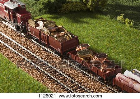 A diorama of a miniature train carrying European Union currency View Large Photo Image Stock Image - A diorama of a miniature train carrying European Union currency. Fotosearch