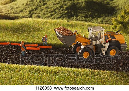 A diorama of miniature construction workers and a bulldozer View Large Photo Image Stock Photo - A diorama of miniature construction workers and a bulldozer. Fotosearch