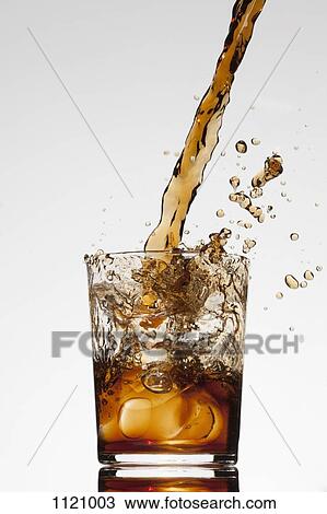A drink being poured into a glass View Large Photo Image Stock Image - A drink being poured into a glass. Fotosearch
