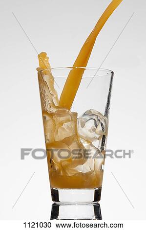 A drink being poured into a glass View Large Photo Image Stock Image - A drink being poured into a glass. Fotosearch