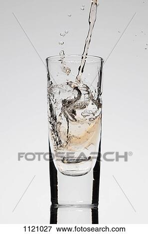 A drink being poured into a glass View Large Photo Image Stock Photo - A drink being poured into a glass. Fotosearch