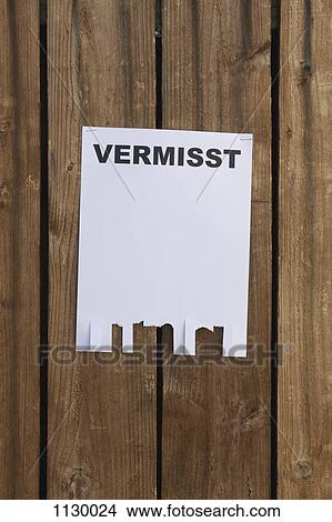 A flyer posted on a wooden fence with the German word for missing on it View Large Photo Image Picture - A flyer posted on a wooden fence with the German word for missing on it. Fotosearch