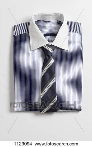 A folded shirt with a tie View Large Photo Image Picture - A folded shirt with a tie. Fotosearch