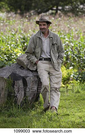 A frowning senior man leaning against a rock View Large Photo Image Stock Image - A frowning senior man leaning against a rock. Fotosearch