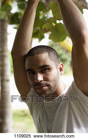 A handsome young man posing outdoors View Large Photo Image Stock Photography - A handsome young man posing outdoors. Fotosearch