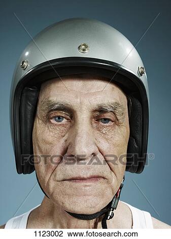 A headshot of a frowning senior man wearing a crash helmet View Large Photo Image Stock Image - A headshot of a frowning senior man wearing a crash helmet. Fotosearch