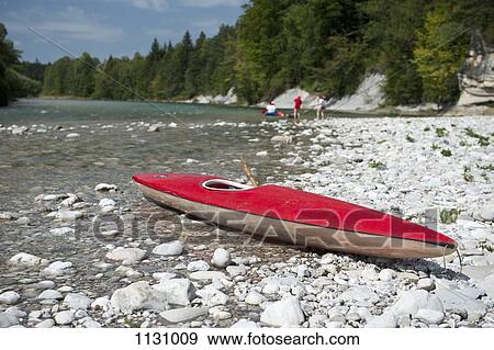 A kayak on a rocky beach View Large Photo Image Stock Photo - A kayak on a rocky beach. Fotosearch