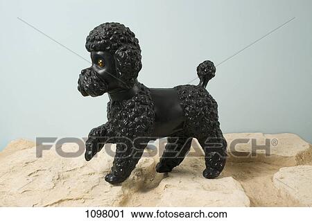 A kitsch dog figurine with paw raised View Large Photo Image Stock Image - A kitsch dog figurine with paw raised. Fotosearch
