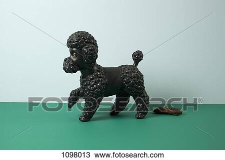 A kitsch dog standing obediently next to his animal dung View Large Photo Image Stock Image - A kitsch dog standing obediently next to his animal dung. Fotosearch