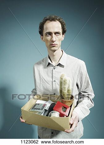 A man carrying a box of possession after being fired View Large Photo Image Stock Image - A man carrying a box of possession after being fired. Fotosearch