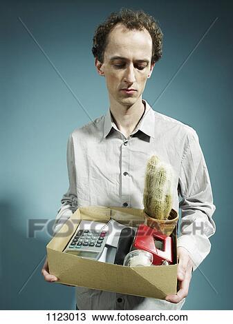 A man carrying a box of possessions after being fired View Large Photo Image Stock Image - A man carrying a box of possessions after being fired. Fotosearch