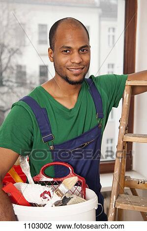 A man holding a bucket of paint supplies preparing to climb a ladder View Large Photo Image Stock Image - A man holding a bucket of paint supplies preparing to climb a ladder. Fotosearch