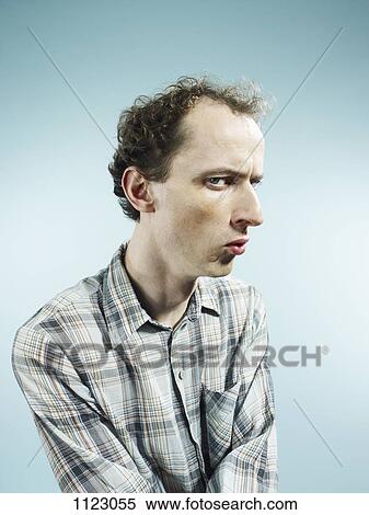 Stock Photography - A man looking suspiciously at the camera. Fotosearch