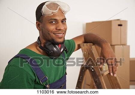 A man preparing to do some renovating, moving house View Large Photo Image Stock Photograph - A man preparing to do some renovating, moving house. Fotosearch