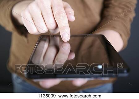 A man using a digital tablet, close-up of hand View Large Photo Image Stock Photo - A man using a digital tablet, close-up of hand. Fotosearch