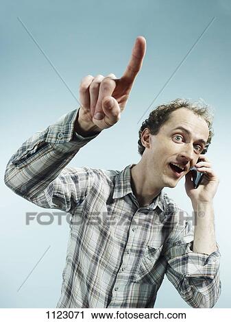 A man using a mobile phone and pointing View Large Photo Image Stock Image - A man using a mobile phone and pointing. Fotosearch