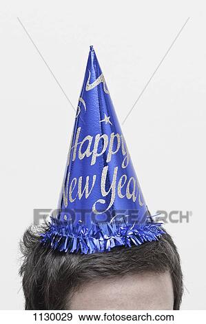 A man wearing a New Year's Eve party hat, top of head View Large Photo Image Stock Photo - A man wearing a New Year's Eve party hat, top of head. Fotosearch