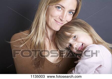 A mother and her young daughter, portrait View Large Photo Image Stock Image - A mother and her young daughter, portrait. Fotosearch