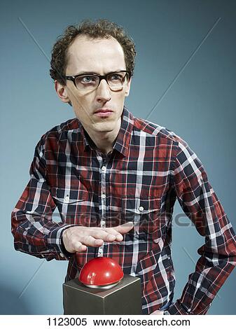 A nerdy guy with his hand poised above a red game show buzzer View Large Photo Image Stock Photography - A nerdy guy with his hand poised above a red game show buzzer. Fotosearch