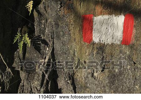 A painted symbol on a rock marking a trail, close-up View Large Photo Image Stock Photo - A painted symbol on a rock marking a trail, close-up. Fotosearch