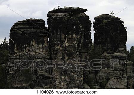 A person climbing a rock formation, Saxon Switzerland, Saxony, Germany View Large Photo Image Stock Photograph - A person climbing a rock formation, Saxon Switzerland, Saxony, Germany. Fotosearch