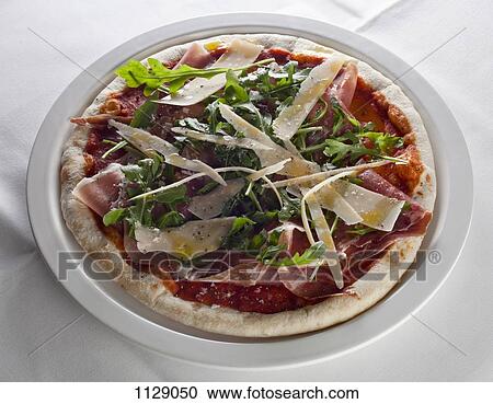 A pizza with ham, rocket, and cheese View Large Photo Image Stock Image - A pizza with ham, rocket, and cheese. Fotosearch