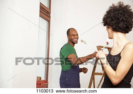 A playful couple having fun while painting apartment View Large Photo Image Stock Image - A playful couple having fun while painting apartment. Fotosearch
