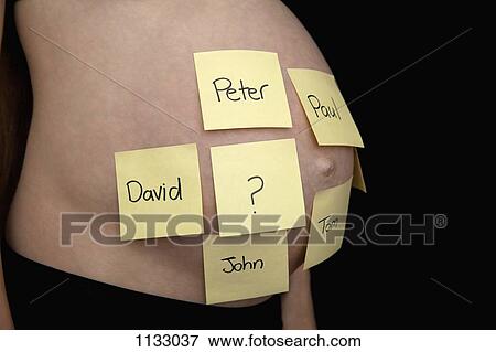 Stock Photo - A pregnant woman's belly with different first names written on sticky notes . Fotosearch