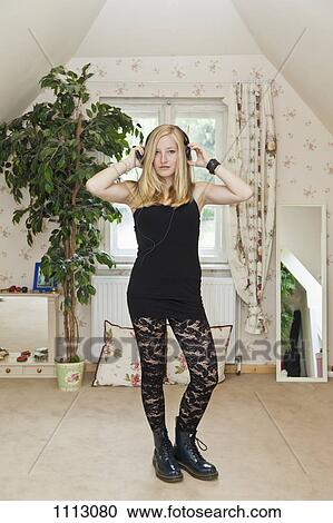 A punk teenage girl standing in a conservatively decorated bedroom View Large Photo Image Stock Image - A punk teenage girl standing in a conservatively decorated bedroom. Fotosearch