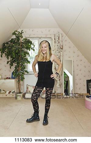A punk teenage girl standing in a conservatively decorated bedroom View Large Photo Image Stock Image - A punk teenage girl standing in a conservatively decorated bedroom. Fotosearch