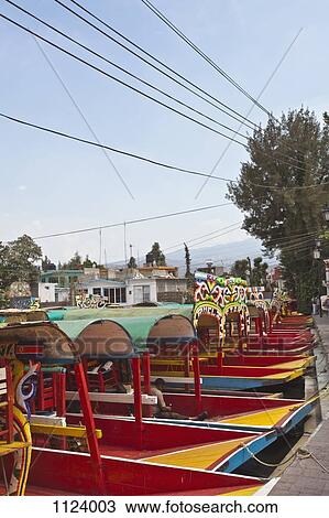 A row of moored Trajineras, a traditional gondola type Mexican tour boat View Large Photo Image Stock Image - A row of moored Trajineras, a traditional gondola type Mexican tour boat. Fotosearch