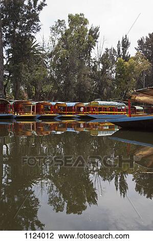 A row of moored Trajineras, a traditional gondola type Mexican tour boat View Large Photo Image Stock Image - A row of moored Trajineras, a traditional gondola type Mexican tour boat. Fotosearch