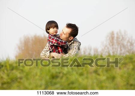 Stock Photo - A sad boy being consoled by his father. Fotosearch