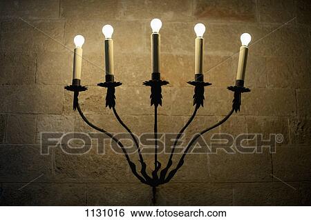 A sconce with illuminated electric candles View Large Photo Image Stock Photograph - A sconce with illuminated electric candles. Fotosearch