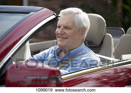 A senior man driving a convertible sports car View Large Photo Image Stock Photo - A senior man driving a convertible sports car. Fotosearch