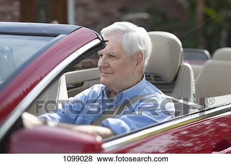 A senior man driving a convertible sports car View Large Photo Image Stock Photo - A senior man driving a convertible sports car. Fotosearch