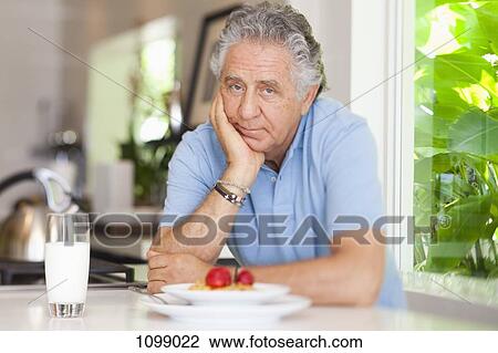A senior man leaning on a counter with his breakfast on it View Large Photo Image Stock Image - A senior man leaning on a counter with his breakfast on it. Fotosearch