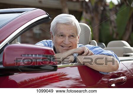 A senior man leaning on the door of his convertible sports car View Large Photo Image Stock Photo - A senior man leaning on the door of his convertible sports car. Fotosearch