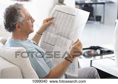A senior man reading the newspaper View Large Photo Image Stock Image - A senior man reading the newspaper. Fotosearch