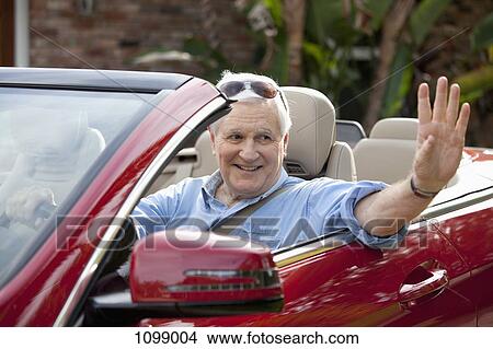 A senior man waving from driver's seat of convertible View Large Photo Image Picture - A senior man waving from driver's seat of convertible. Fotosearch
