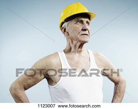 Stock Photo - A senior man wearing a hardhat and tank top. Fotosearch