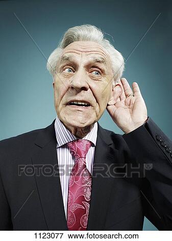 A senior man with his hand behind his ear View Large Photo Image Stock Photo - A senior man with his hand behind his ear. Fotosearch